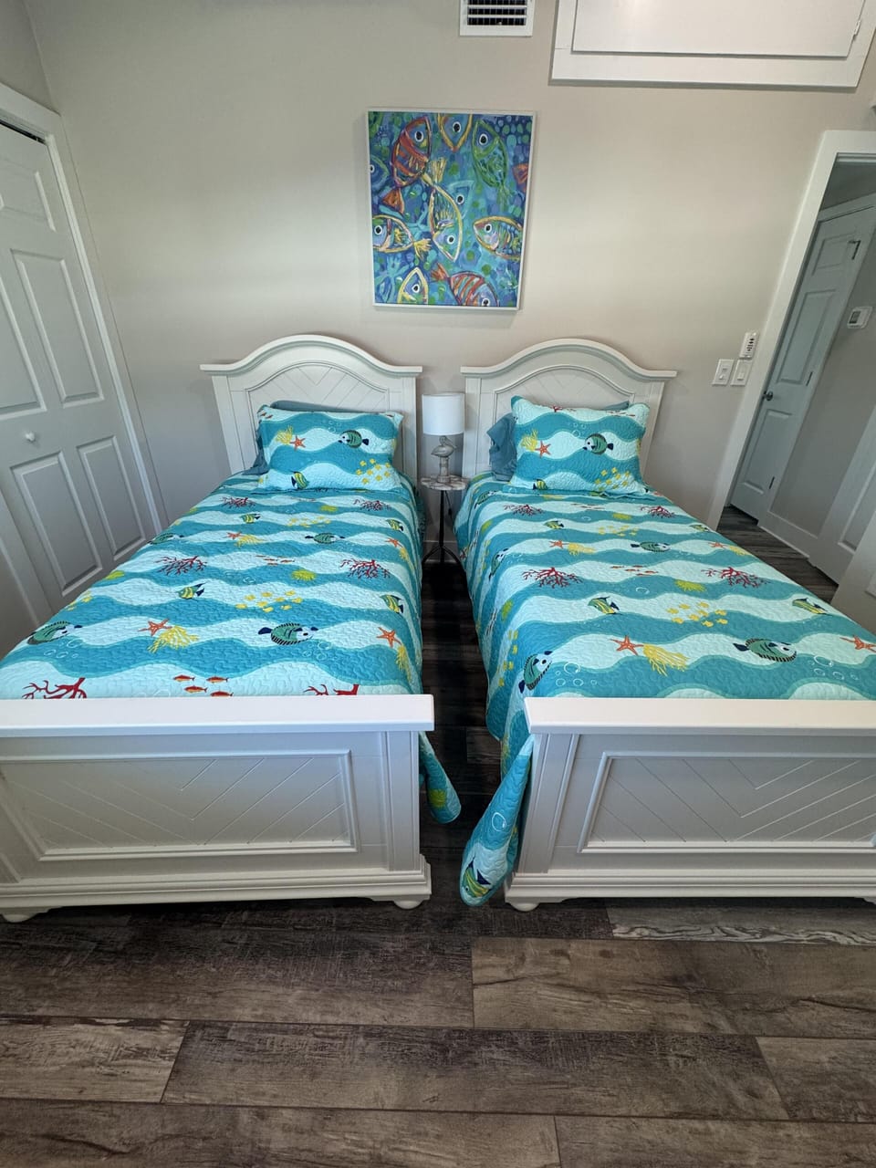 Twin bedroom with vibrant coastal-inspired decor