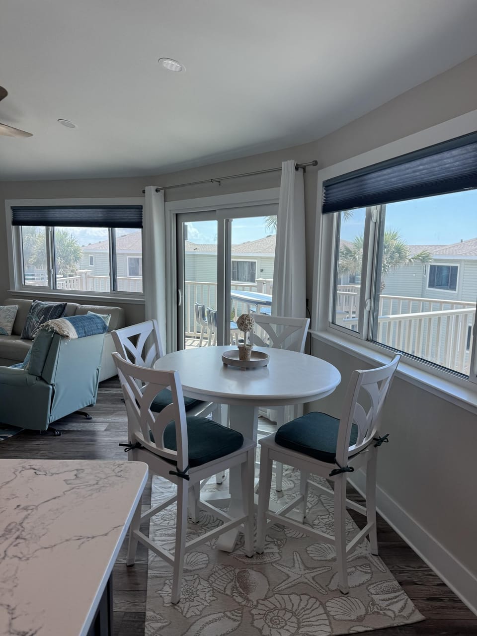 Sunlit dining nook with panoramic window views