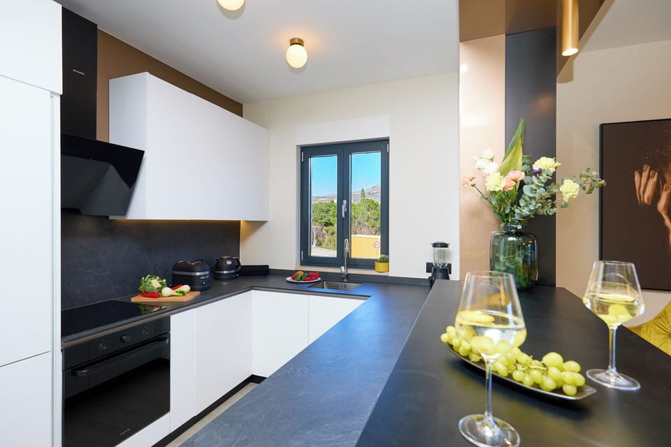 Craft meals in the sleek, fully equipped kitchen, featuring modern appliances and a breakfast bar perfect for sipping morning coffee.