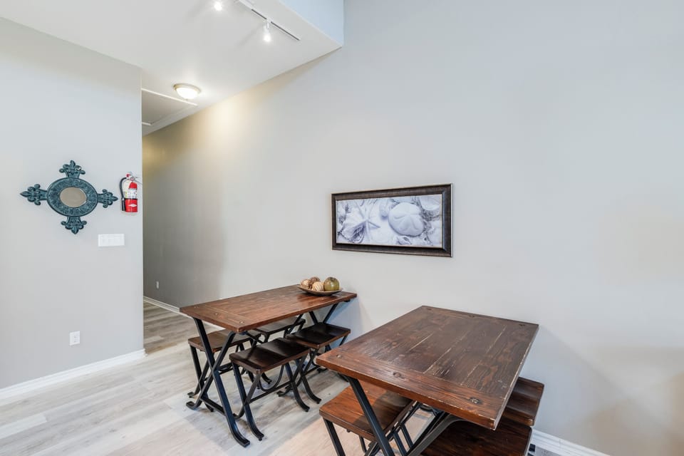Gather around rustic dining tables where shared meals become cherished memories in this warm, welcoming space.