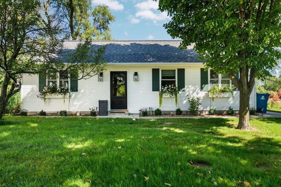 Classic cottage charm with curb appeal 🌿

A welcoming front entry, blooming window boxes, and a peaceful yard surrounded by mature trees.