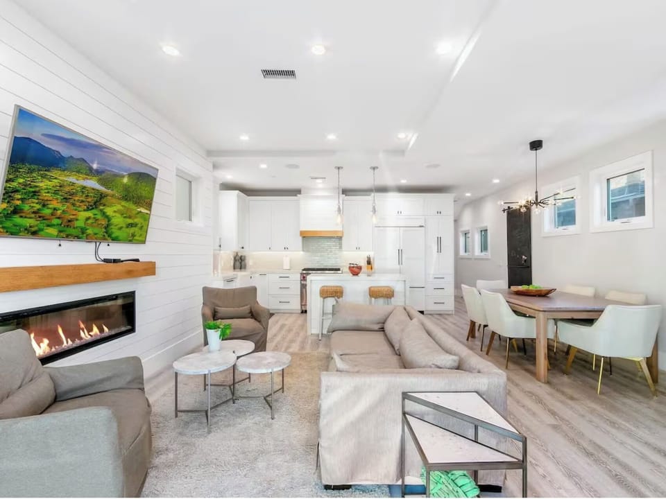 Another angle of Unit A's bright, open living area showcasing the modern layout, comfortable seating, and seamless flow into the kitchen and dining space.