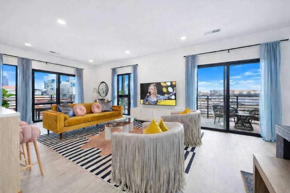 Unit 2: Trendy and spacious living room featuring modern designer furnishings, and a Smart TV for entertainment.