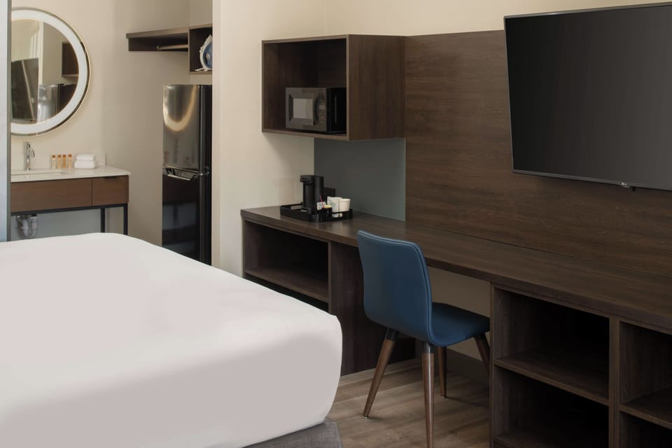 Settle in with a dedicated workspace, big TV, and fridge.