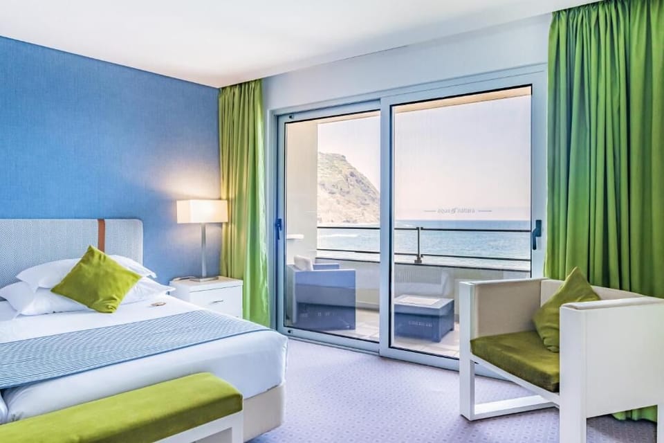 Lounge in bed as sunlight pours in from the sea.