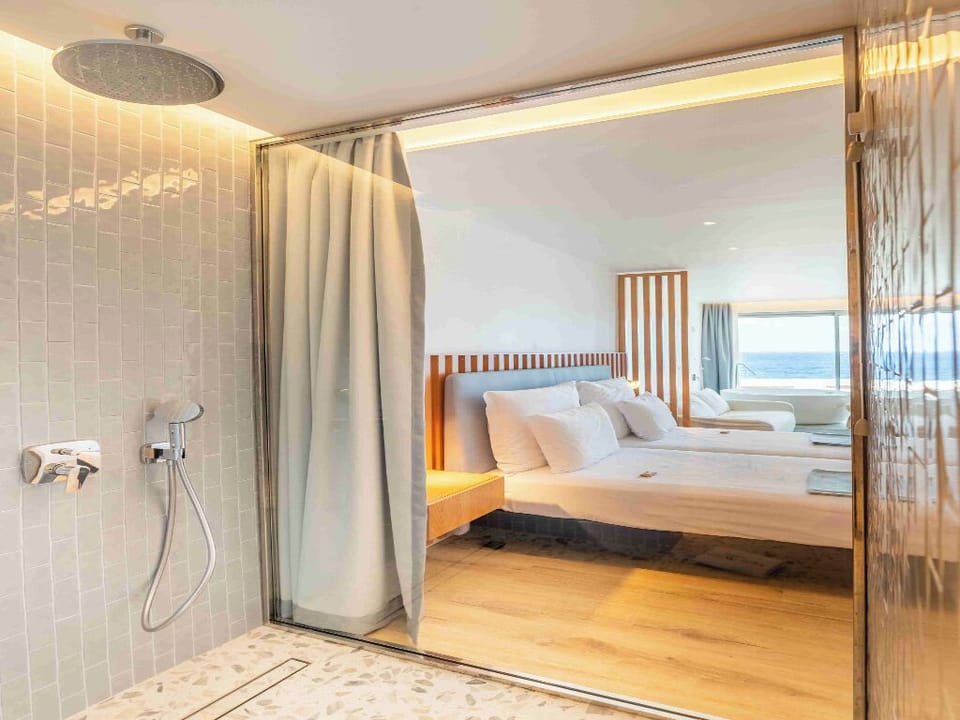 Rinse off under a rainfall shower, steps from bed.