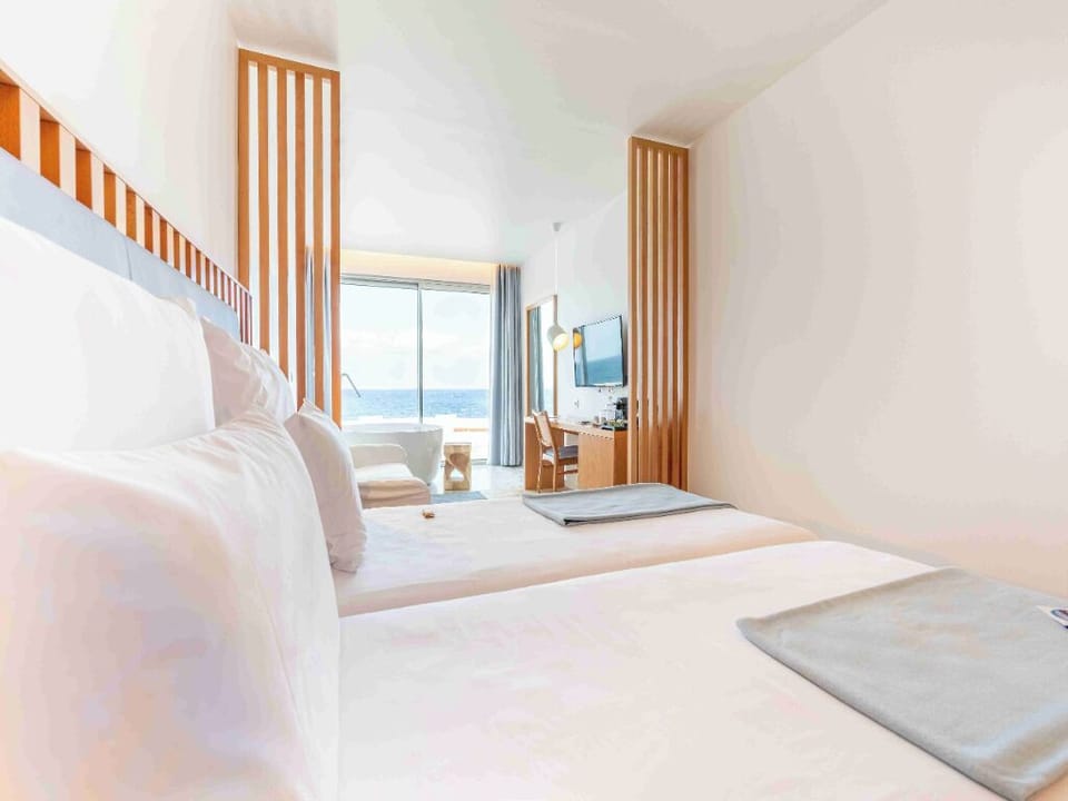 Stretch out in a spacious room framed by sea views.