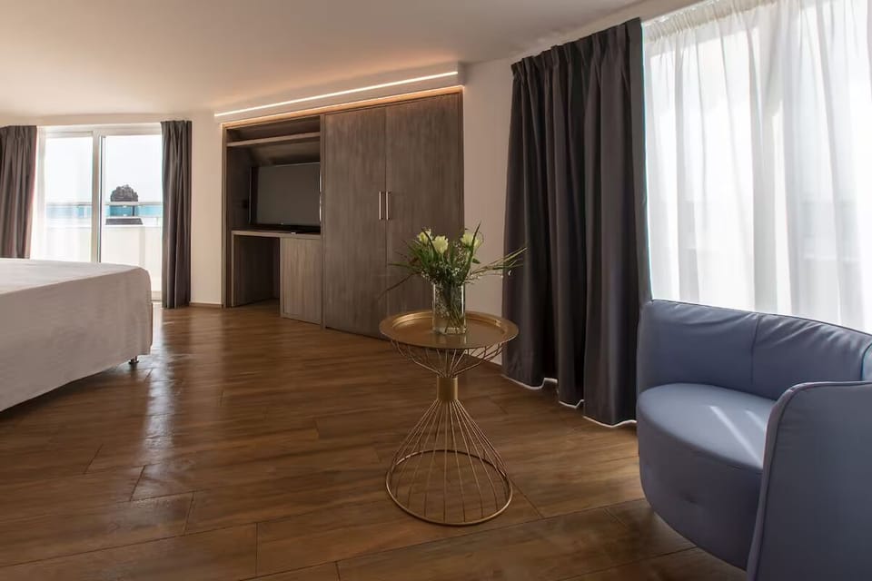 Unwind in a spacious room with warm wood floors.
