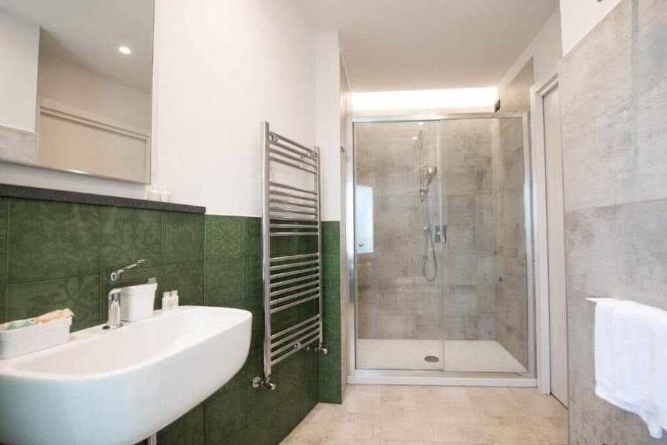 Rinse off in a bright, glass-enclosed rainfall-style shower.