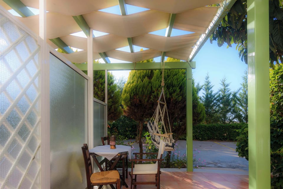Covered Outdoor Patio with Dining Area and Garden Views
