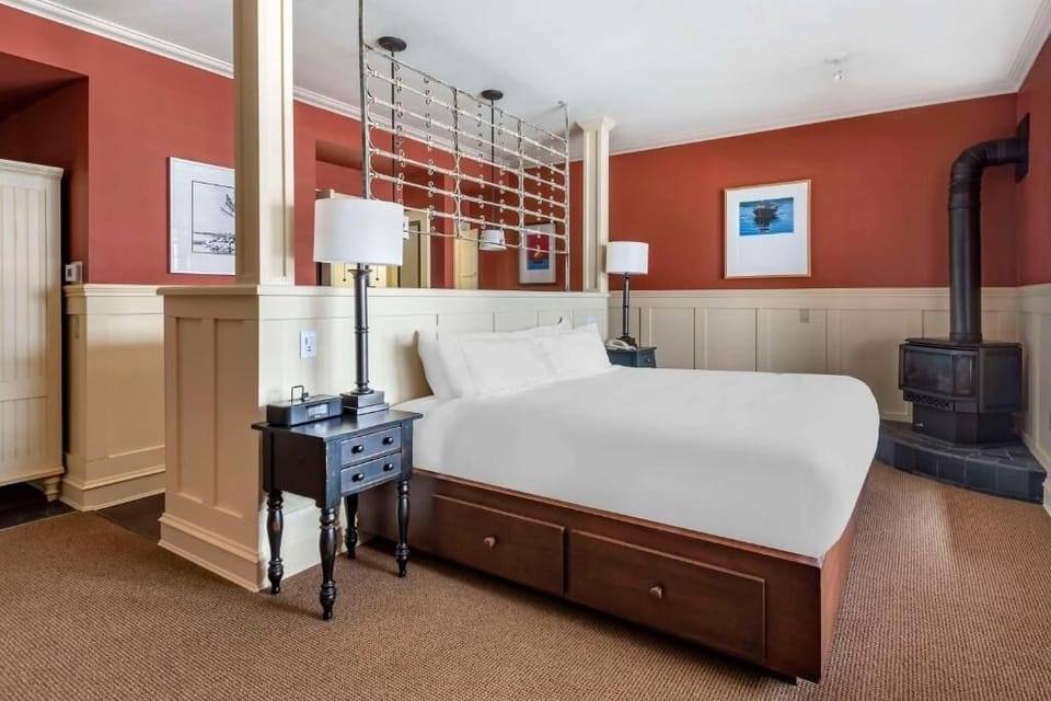Unwind in a cozy king bed with warm lodge charm.