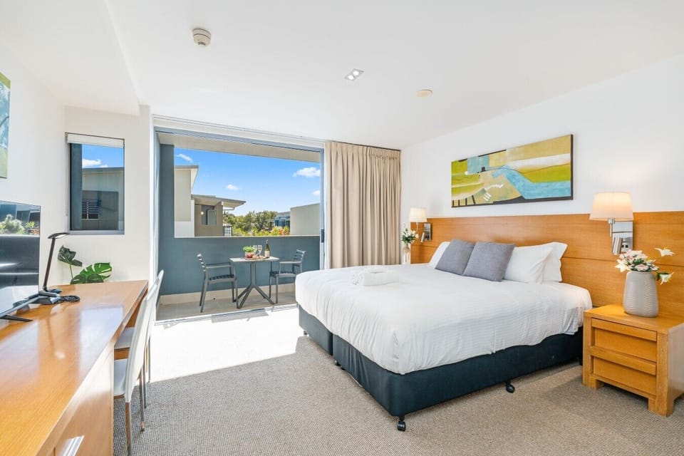 Rest up in this well-appointed bedroom featuring a queen bed, bedside lighting, and a full-length mirrored wardrobe.