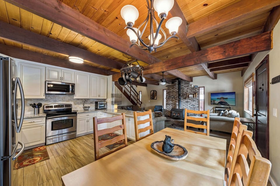 You'll love gathering in this stunning open-concept space with exposed wooden beams, modern kitchen, and cozy dining nook.