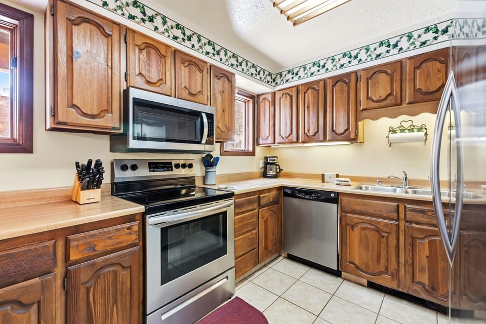 Your fully equipped kitchen features warm wood cabinets, stainless appliances, and everything you need to prepare memorable meals during your stay.