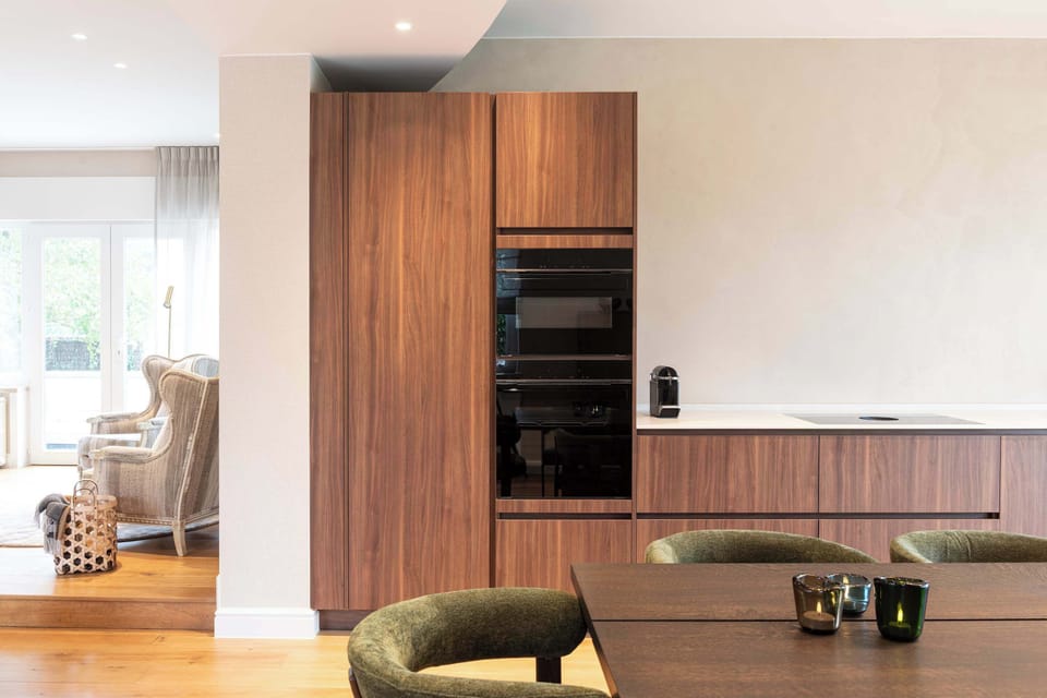 Elegant open-plan kitchen with modern design and warm, natural finishes