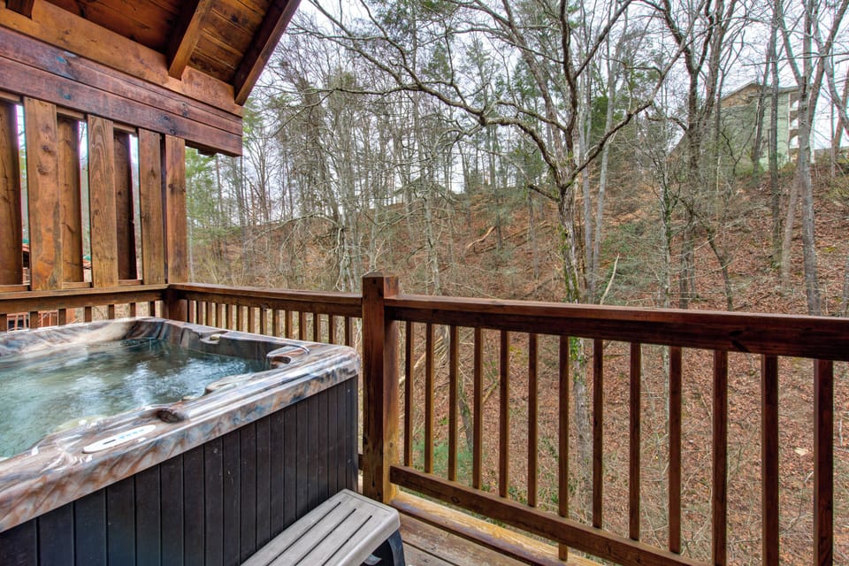 Soak away your stress in your private hot tub while enjoying peaceful wooded views from your secluded deck.