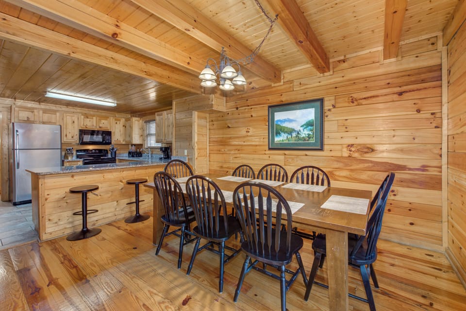 Gather around this spacious wooden dining table where your group can share memorable meals in the warm, rustic charm of natural wood.