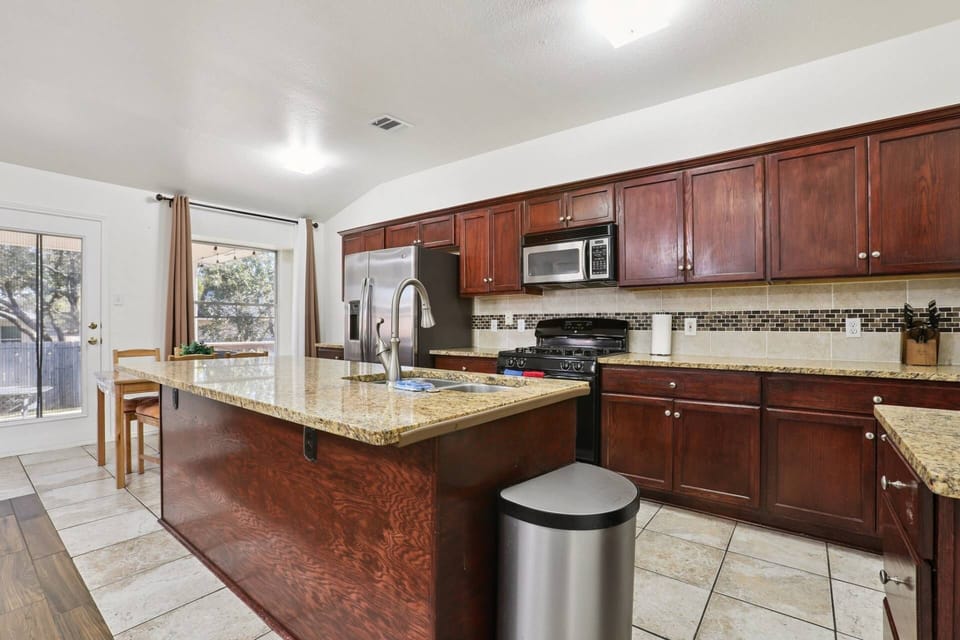Fully stocked kitchen with extras like a sandwich press, mixer, and blender