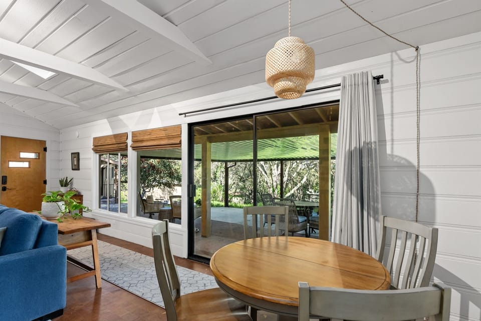 Light-filled dining area with sliding doors opening to the covered outdoor patio.