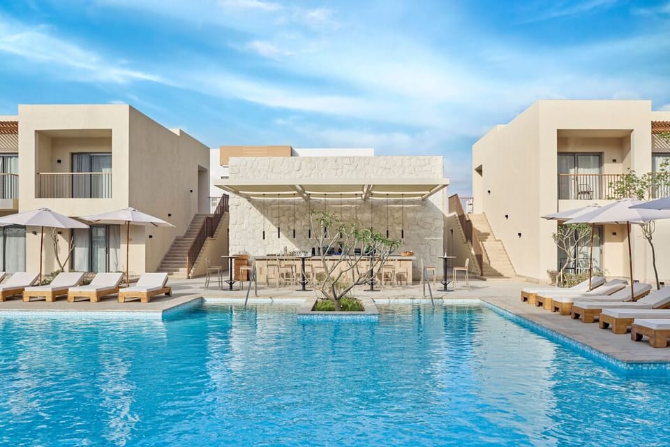 Dive into a serene courtyard pool framed by modern suites