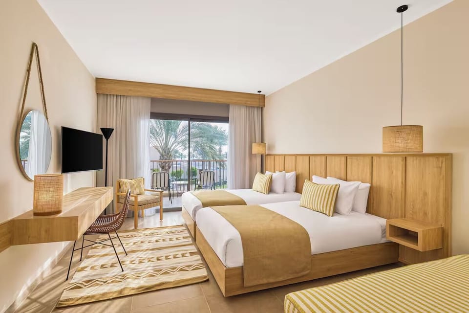 Unwind in sunlit twin beds with a breezy balcony view.