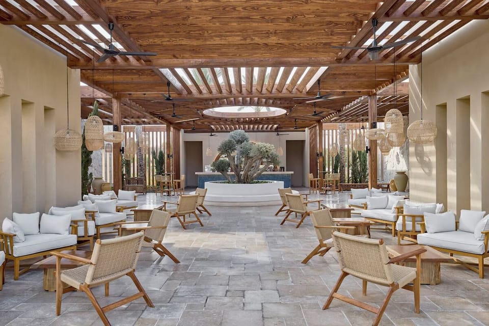 Settle into airy lounge seating beneath warm, sculpted wood.