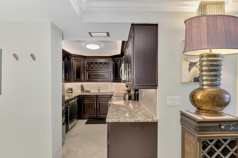 Your gourmet kitchen awaits with rich dark cabinetry, granite countertops, and premium appliances for memorable culinary experiences.
