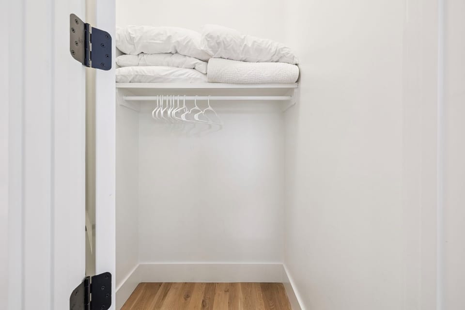 Your spacious walk-in closet features hanging space and soft towels on the upper shelf for your convenience.
