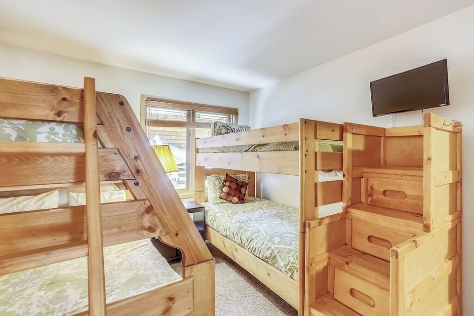 Sleep soundly in your cozy bunk room featuring sturdy wood beds, soft linens, and entertainment on demand.