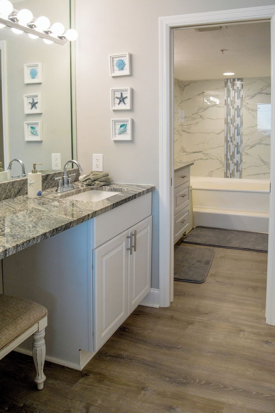 Your elegant bathroom features granite counters and coastal charm, with a luxurious marble shower awaiting your relaxation.