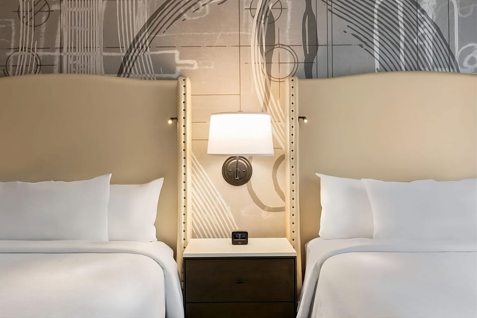 Rest easy with flexible twin beds and warm bedside lighting.