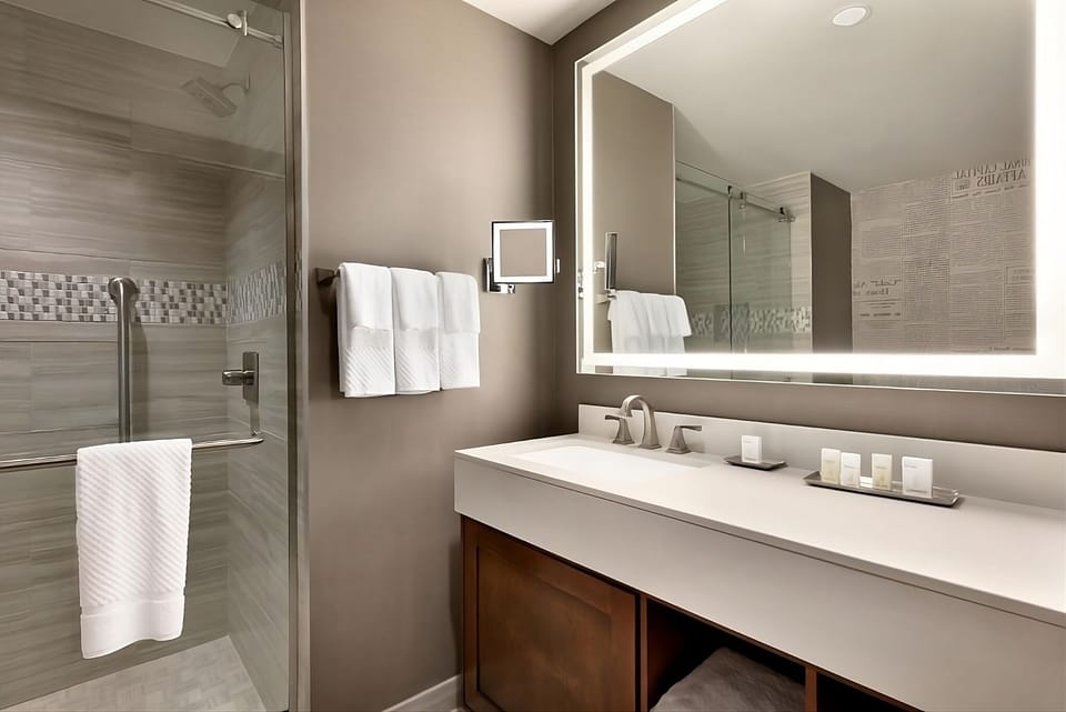 Refresh under a spa-like shower beside a glowing vanity.
