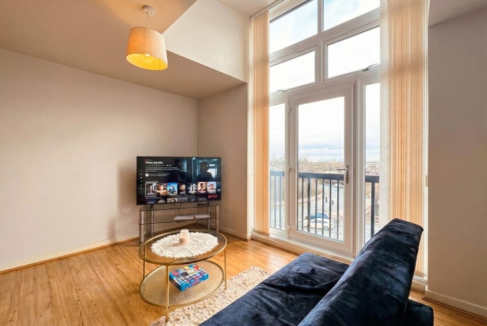 Floor-to-ceiling windows pour daylight into the lounge with a sweeping city view beyond.