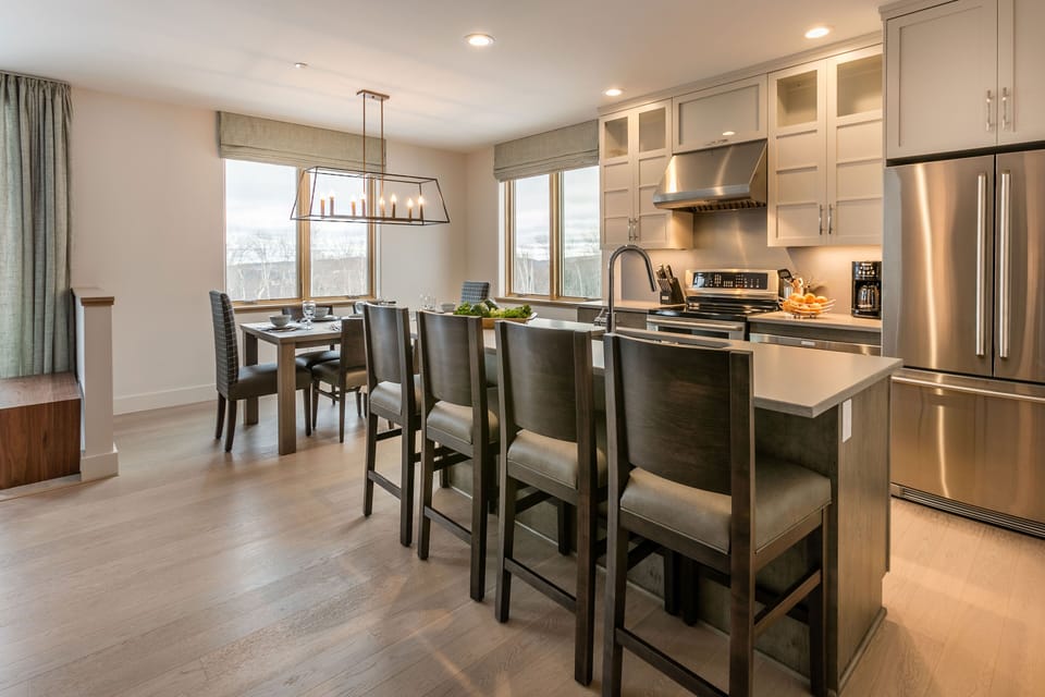 Bathed in natural light, the dining area offers comfortable seating and a welcoming space to gather after mountain adventures.