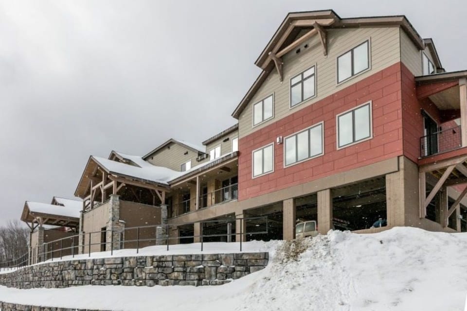 Nestled into the landscape, the South Face Village Condominiums exude rustic charm, offering modern amenities while harmonizing with the stunning Vermont scenery.