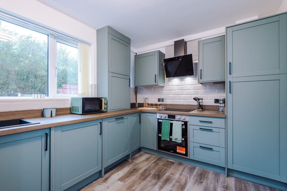 Stylish Kitchen: Experience modern elegance with sleek cabinets and a sunny view perfect for cooking!
