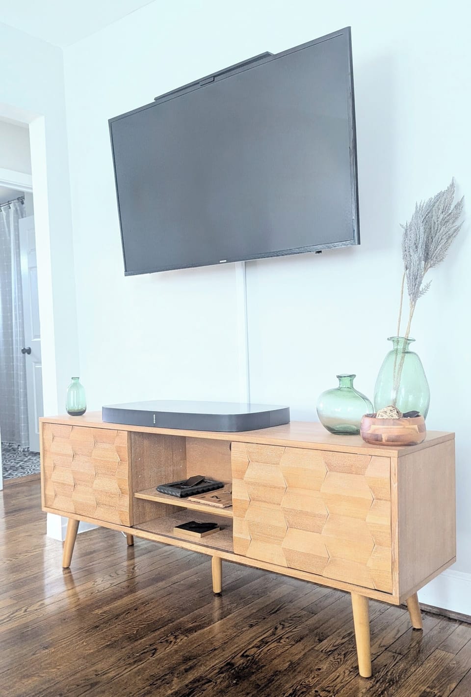 Living Room - Wall-mounted TV with soundbar on mid-century console