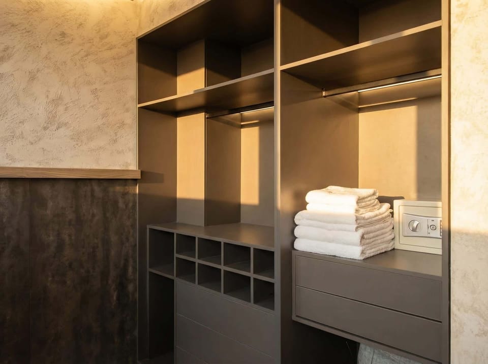 Storage Haven: Spacious wardrobe with stylish design and fresh towels for your comfort!