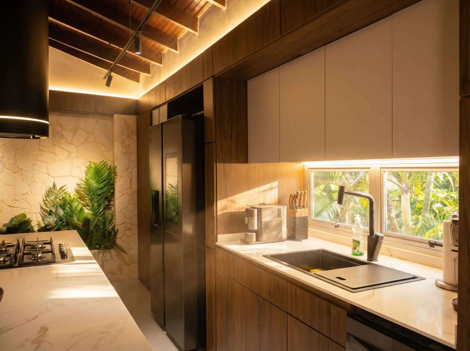 Kitchen: Bright space with modern appliances and tropical views for culinary inspiration!