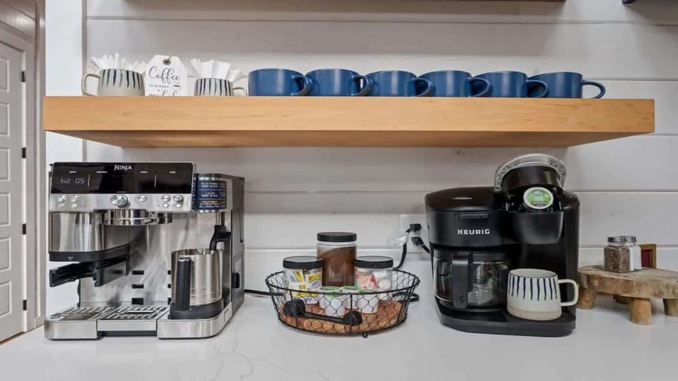 Fully stocked coffee bar with Keurig and espresso machine setup.