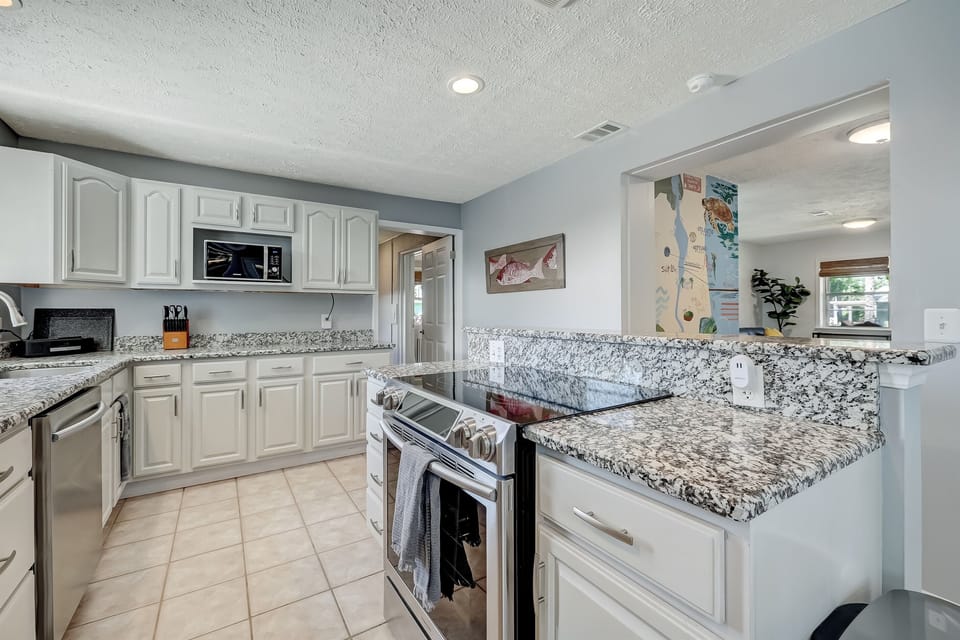 Fully equipped kitchen with granite countertops and stainless appliances.