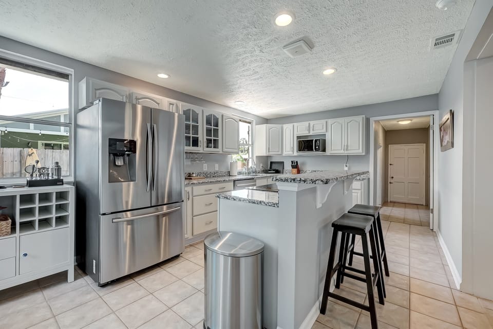 Spacious kitchen with bar seating and open layout.