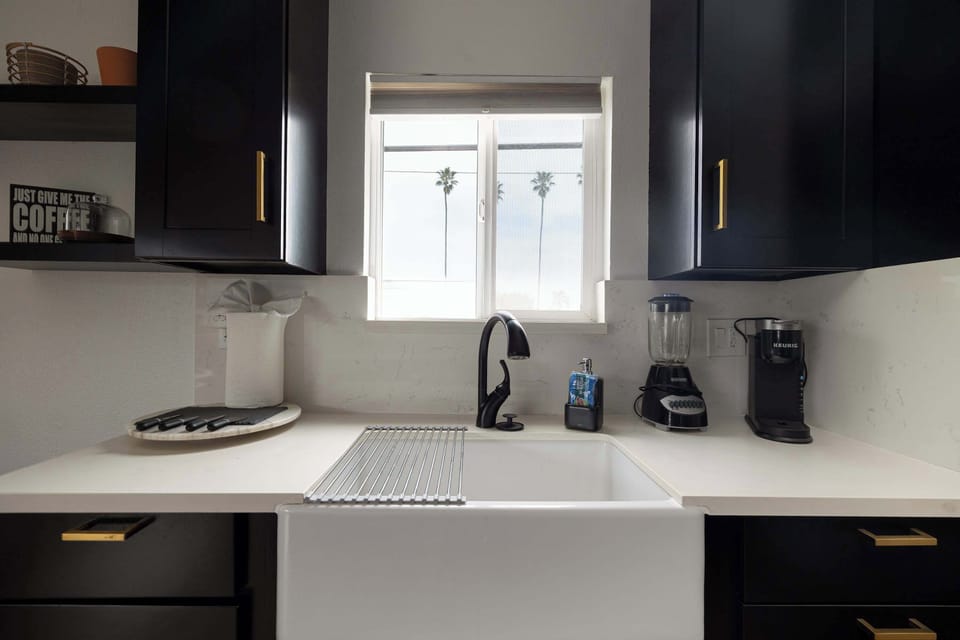 Sunlit sink space with everything you need within reach.