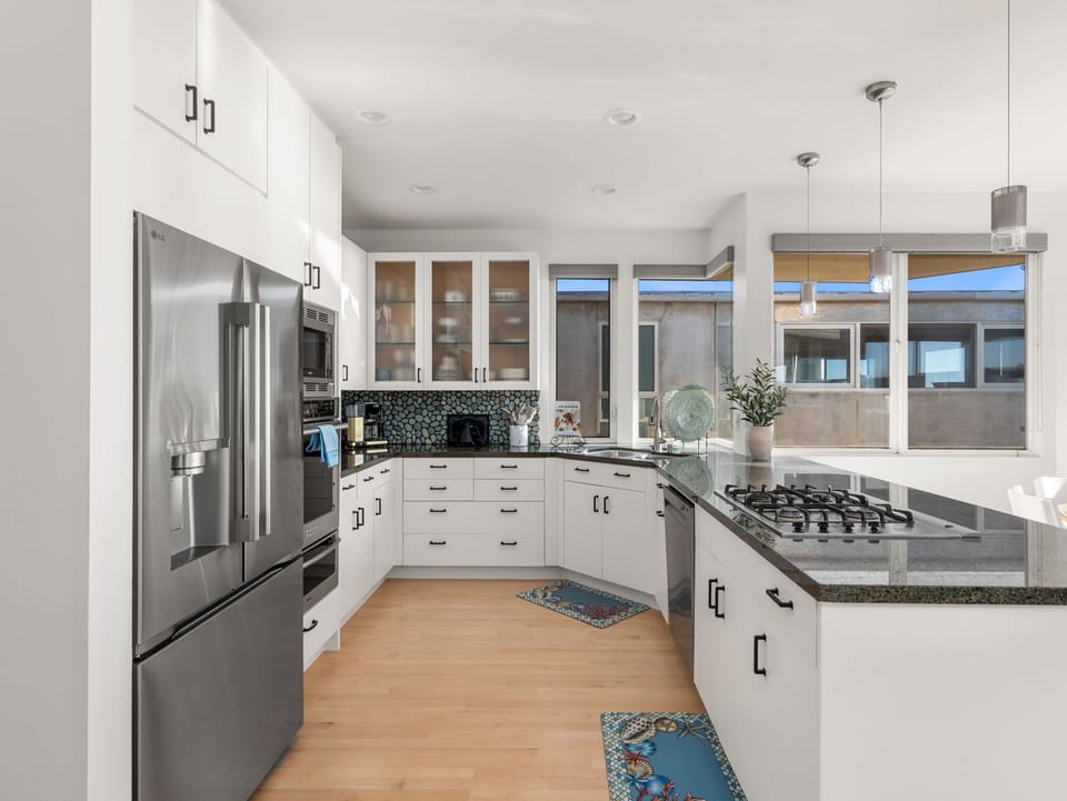 Spacious chef’s kitchen featuring a gas cooktop, generous counter space, and full size appliances for effortless home cooking.