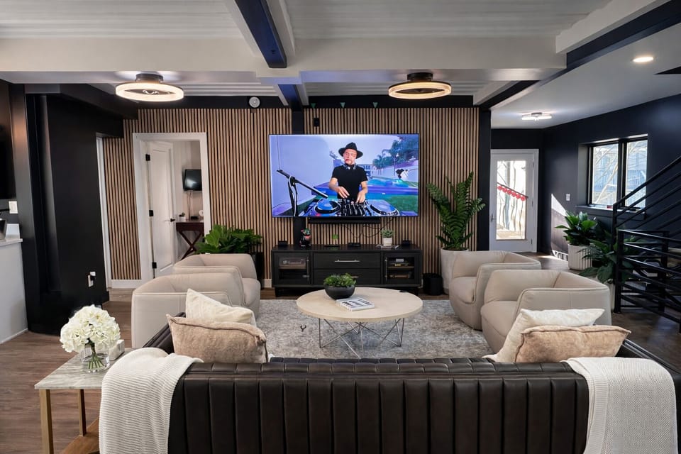 Incredible Living Room with Stunning Leather Sofa, Leather Swivel Chairs, and High Definition 85" Smart TV with Vizio Sound System.