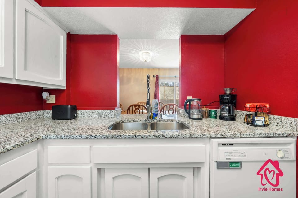 Bold kitchen with red walls and granite countertops.