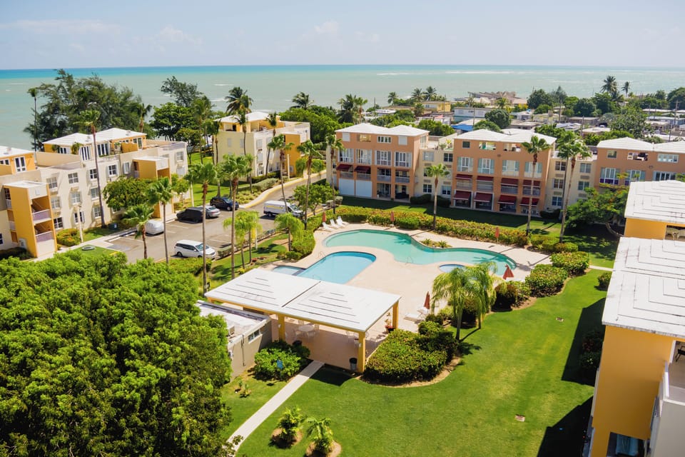 The complex features two pools and a children’s pool, and lounge chairs. 