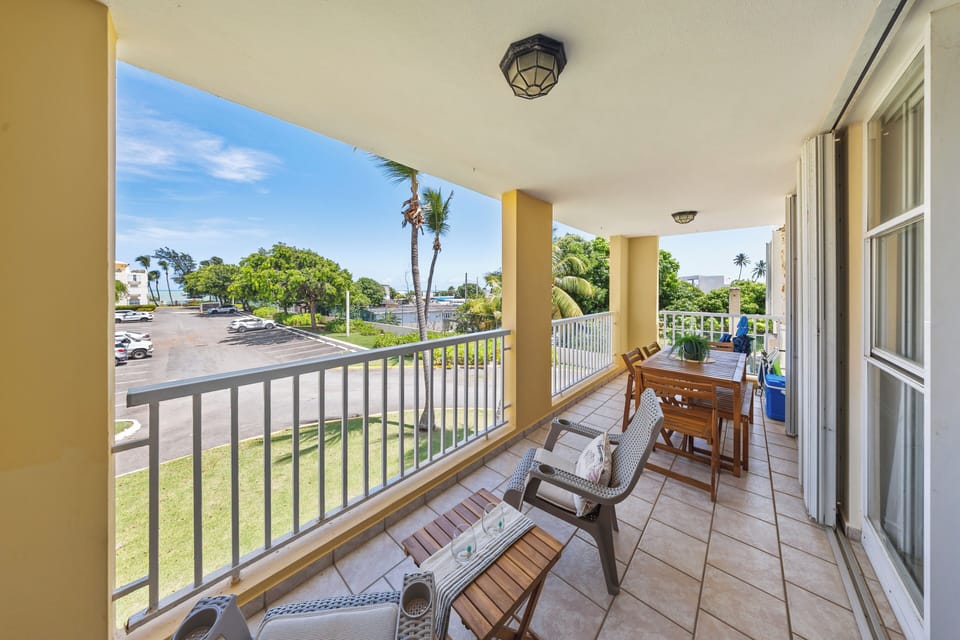 Enjoy a spacious balcony with partial ocean view and seating.