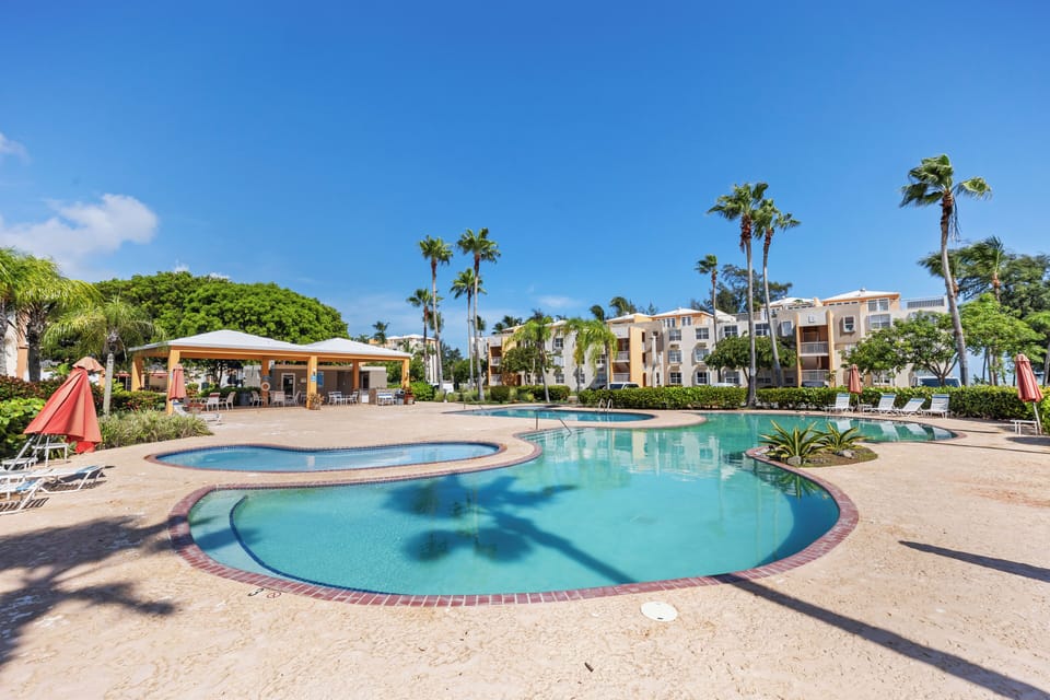 Enjoy two large pools and a kids’ pool with chairs, umbrellas, and shaded areas.