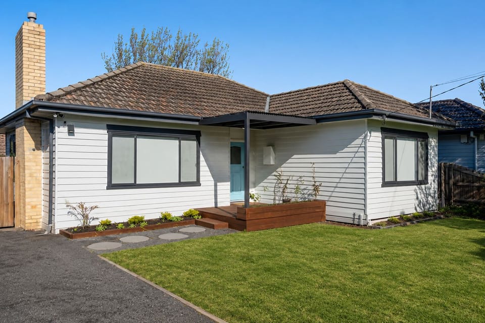 Modernized cottage with covered porch, easy parking, sunny lawn